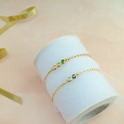 Two gold anklets with blue topaz and  iolite, one anklet with green onyx, peridot and pink chalcedony. 