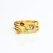 Set of 4 gold plated dainty 3mm gemstone rings featuring garnet, purple amethyst, peridot and citrine.  On white background. 925 sterling silver, birthstone ring, stacking ring, stackable, birthstone jewelry, facet gemstone