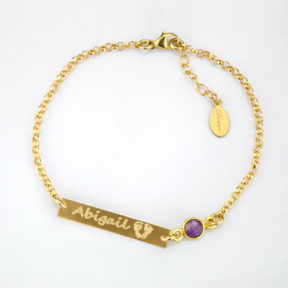 Single gold filled adjustable bar bracelet with name and footprints engraved with a purple amethyst birthstone. 