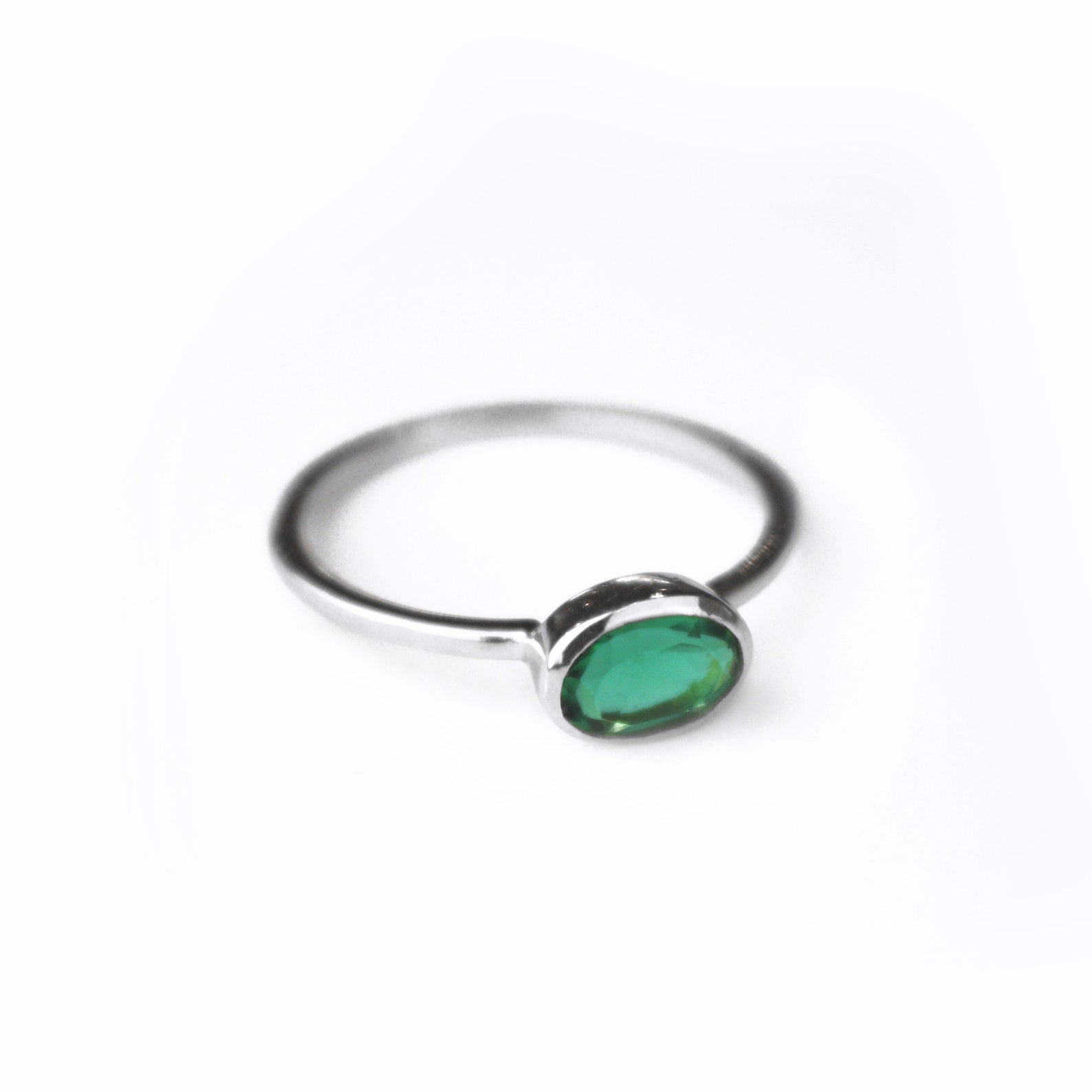 sterling silver green tourmaline ring shown on white background. stackable! Stacking rings, bezel set, small oval, tiny oval, dainty oval, birthstone rings, sterling silver stamp, birthstone ring, birthstone jewelry, green gemstone, green birthstone, october birthstone, october gemstone