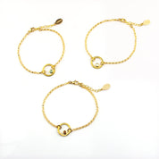 three gold plated open circle pendant charm birthstone bracelets featuring aqua chalcedony, clear quartz and garnet birthstones. March birthstone, January birthstone, april birthstones. gemstone jewelry on white background. 