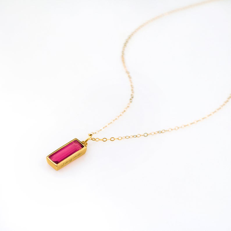 Single gold filled cable chain with ruby quartz vertical adira bar necklace with side engraved July birthstone on white background