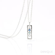 Single sterling silver open frame necklace with kyanit, blue topaz and moonstone birthstones. 