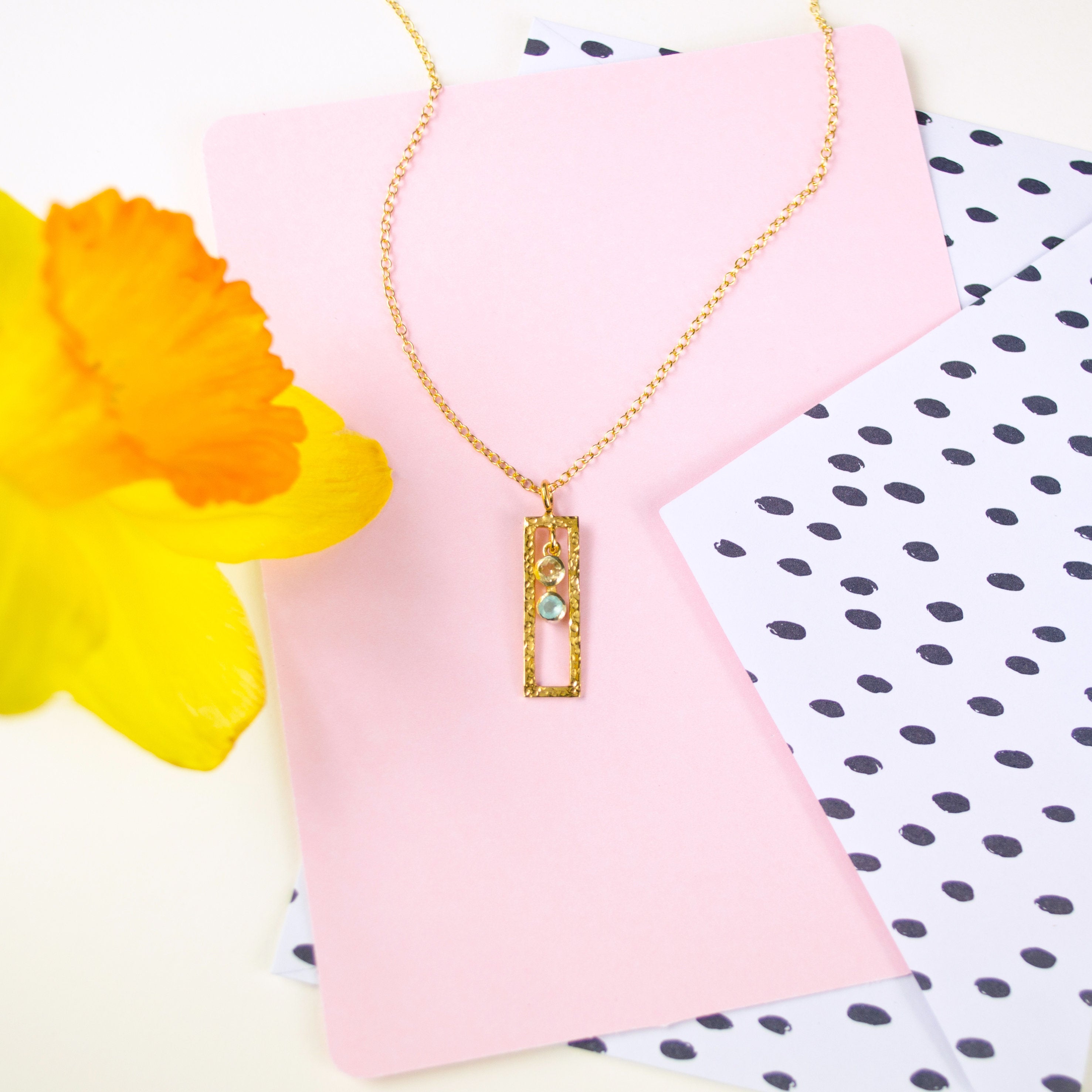 Single gold filled open frame necklace with peridot and aqua chalcedony birthstones.