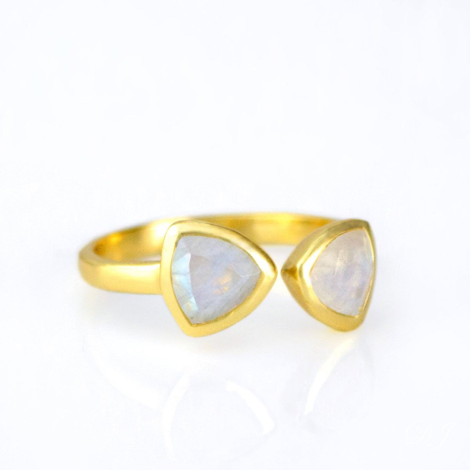 A gold moonstone triangle bow tie ring. Moonstone bow tie ring, adjustable Moonstone ring, double triangle Moonstone, custom Moonstone jewelry, sterling silver Moonstone ring, gold Moonstone bow tie ring, rose gold Moonstone ring, unique Moonstone ring, triangle-cut Moonstone, personalized Moonstone ring, Moonstone stacking ring, bespoke Moonstone jewelry, elegant Moonstone gift, adjustable gemstone ring, Moonstone birthstone ring, custom Moonstone gift, trendy bow tie ring, mystical Moonstone ring