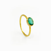 a gold green tourmaline ring shown on white background. stackable! Stacking rings, bezel set, small oval, tiny oval, dainty oval, birthstone rings, sterling silver stamp, birthstone ring, birthstone jewelry, green gemstone, green birthstone, october birthstone, october gemstone