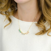 Model is wearing a gold filled adira necklace with green onyx, moonstone and pink quartz stones. 