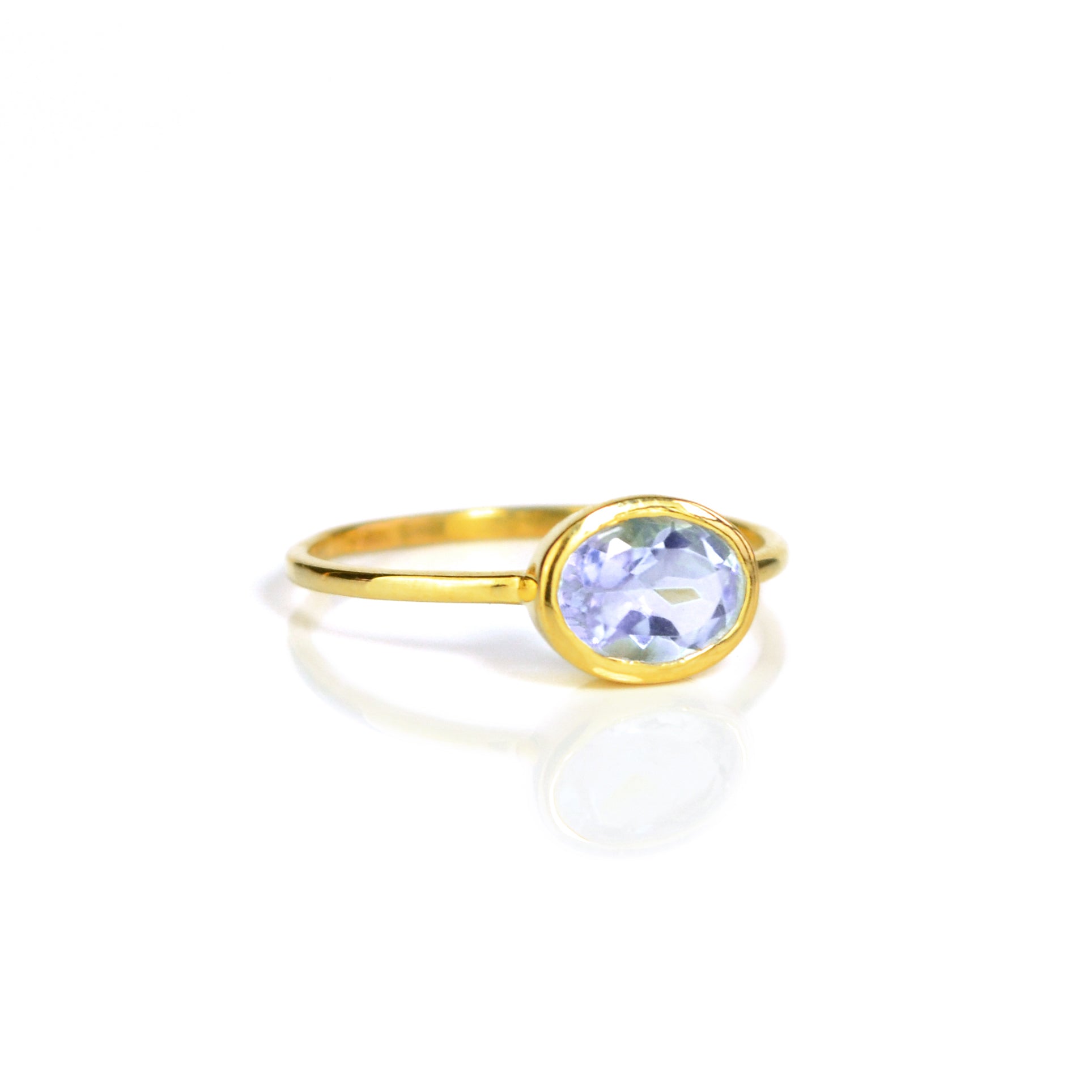 a gold alexandrite ring shown on white background. stackable! Stacking rings, bezel set, small oval, tiny oval, dainty oval, birthstone rings, sterling silver stamp, birthstone ring, birthstone jewelry, purple gemstone, purple birthstone, june birthstone, june gemstone, stack set, stacking rings, gemstone ring, birthstone ring, mother's day gift for her, gift for mom, gift for fiance, gift for girlfriend, wedding jewelry, bridesmaid, anniversary jewelry, anniversary gift, birthday gift, christmas gift