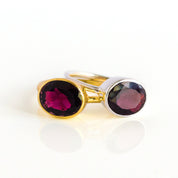 Pair of round-cut almandine garnet bezel-cup rings in yellow gold vermeil and bright 925 sterling silver; low-profile, comfort-fit bands that stack smoothly; ethical, hypoallergenic, nickel-safe January birth month jewelry handcrafted in a Massachusetts studio; modern minimalist solitaire style for bridesmaid proposals, push-present or graduation gifts; available ring sizes 5–10 and ready-to-gift packaging.