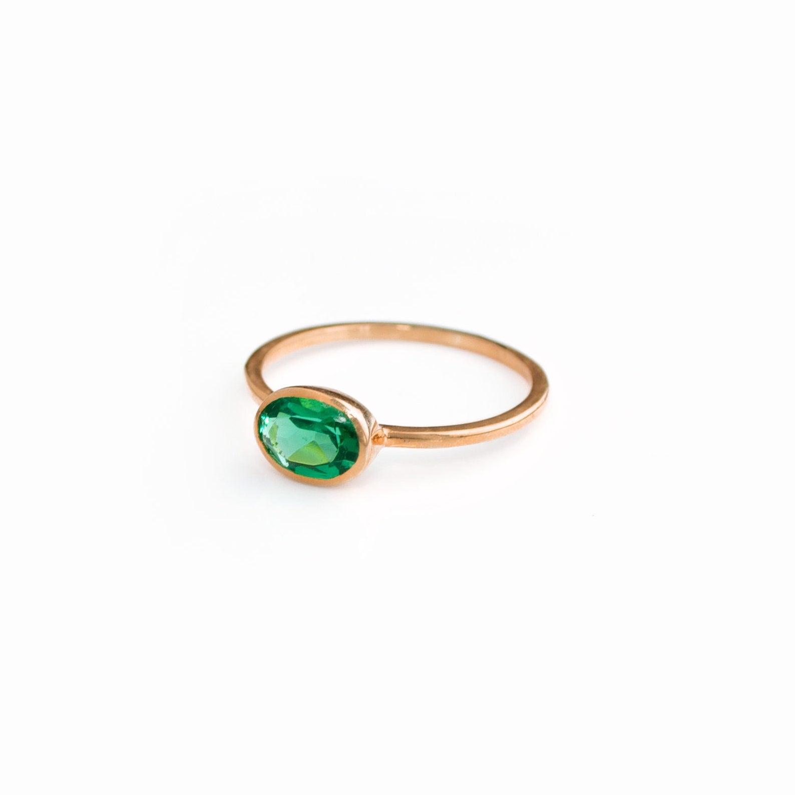 a rose gold green tourmaline ring shown on white background. stackable! Stacking rings, bezel set, small oval, tiny oval, dainty oval, birthstone rings, sterling silver stamp, birthstone ring, birthstone jewelry, green gemstone, green birthstone, october birthstone, october gemstone