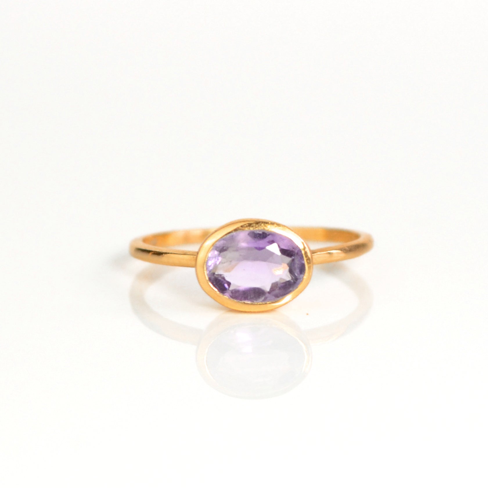 a rose gold purple amethyst ring shown on white background. stackable! Stacking rings, bezel set, small oval, tiny oval, dainty oval, birthstone rings, sterling silver stamp, birthstone ring, birthstone jewelry, purple gemstone, purple birthstone, february birthstone, february gemstone