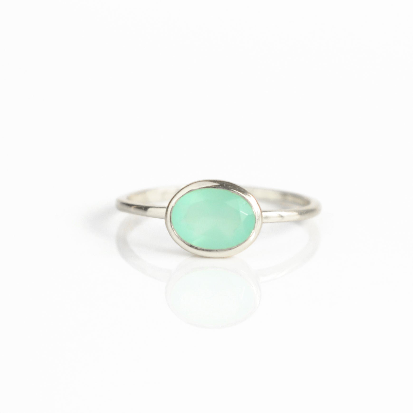 a sterling silver aqua chalcedony ring shown on white background. Stacking rings, bezel set, small oval, tiny oval, dainty oval, birthstone rings, sterling silver stamp, birthstone ring, birthstone jewelry, march birthstone, march gemstone, stack set, stacking rings, gemstone ring, birthstone ring, mother's day gift for her, gift for mom, gift for fiance, gift for girlfriend, wedding jewelry, bridesmaid jewelry, anniversary jewelry, anniversary gift, birthday gift, christmas gift, valentine's day gift