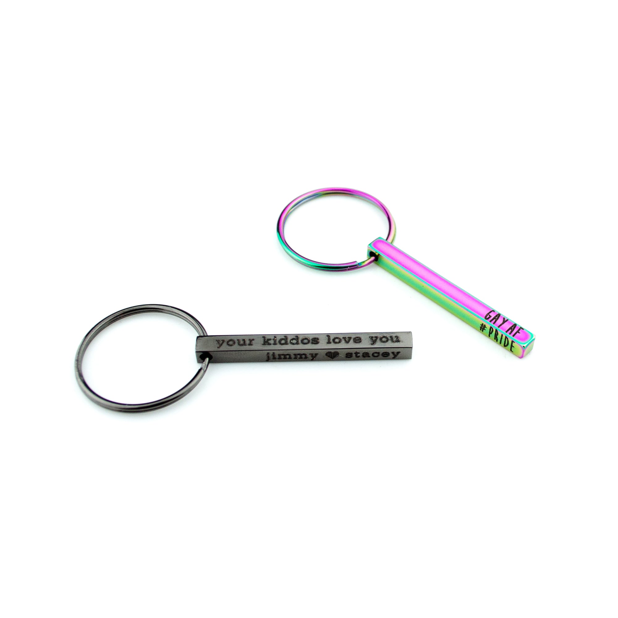 Modern black and vibrant rainbow personalized 3D bar keychains laid out on a bright white surface, each with precise laser engraving along the edge. These bold finishes make a standout custom keyring for men or teens while keeping the bar petite and lightweight. Ideal coordinates keychain or “drive safe” reminder; great stocking stuffers and graduation gifts.