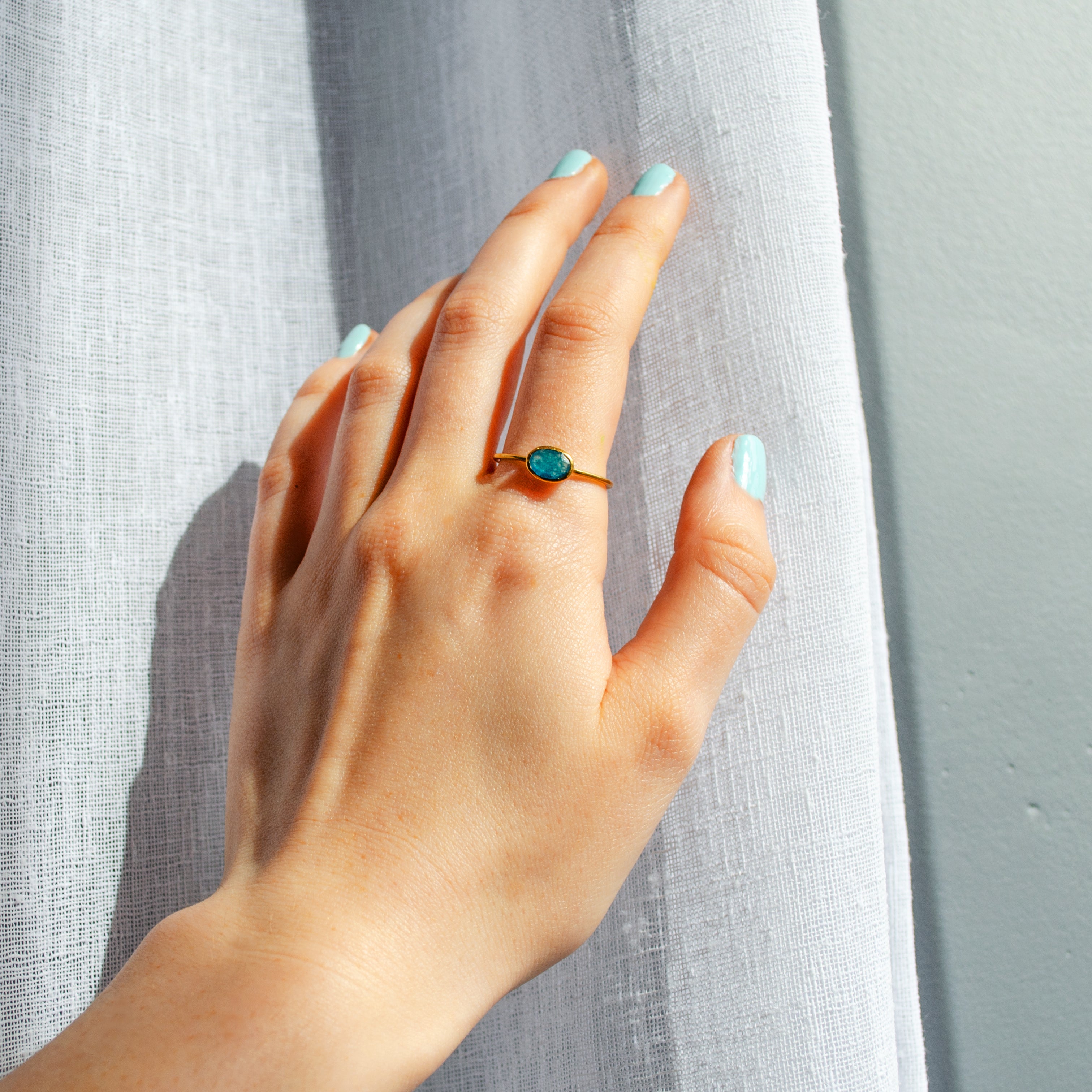 model is wearing a gold blue black jade ring. stackable! Stacking rings, bezel set, small oval, tiny oval, dainty oval, birthstone rings, sterling silver stamp, birthstone ring, birthstone jewelry