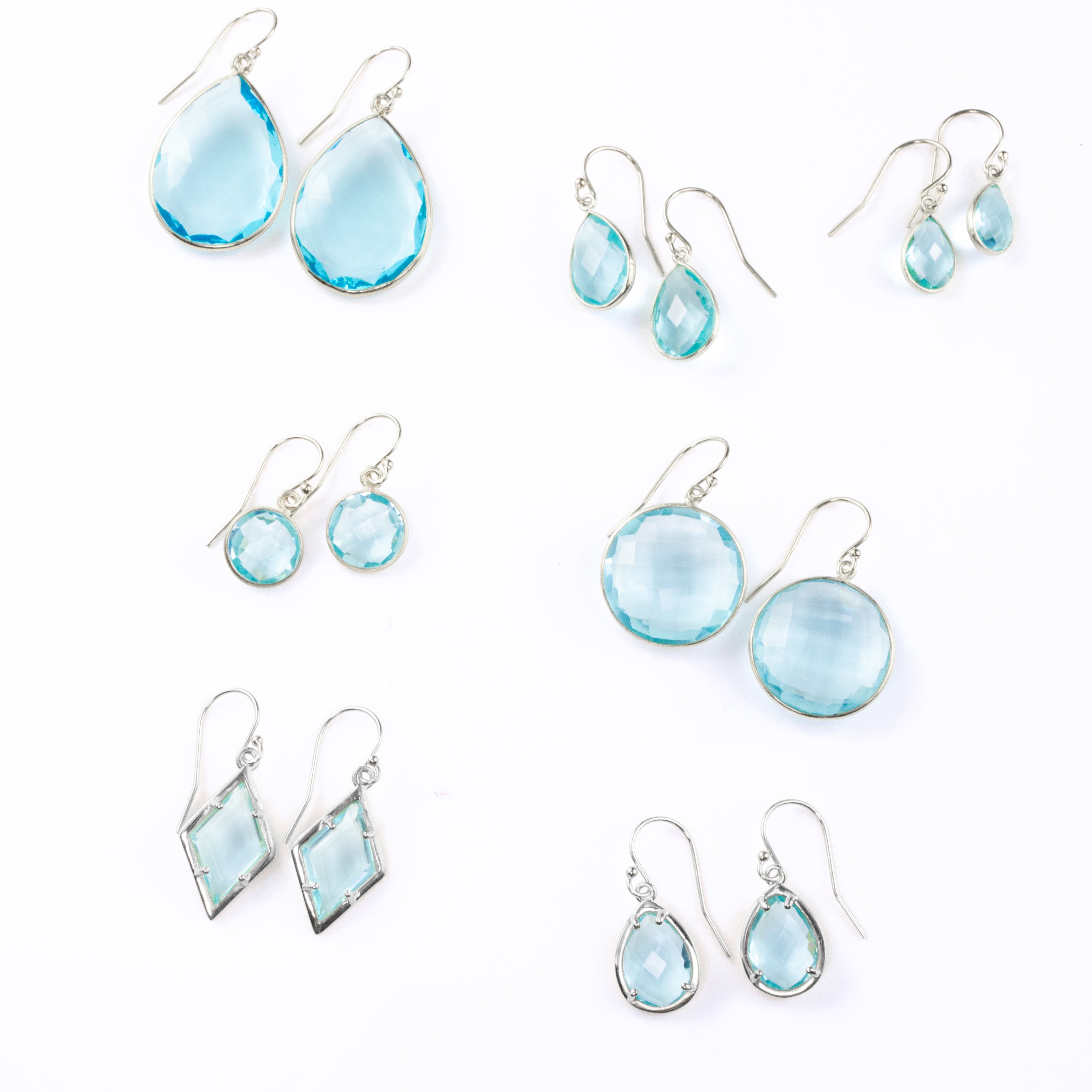 Sterling silver blue topaz birthstone earrings. December birthstone. December gemstone. Shapes and sizes include Small, medium and large teardrop gemstones and large and medium round gemstones. November birthstone on white background