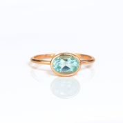 a rose gold blue topaz ring shown on white background. stackable! Stacking rings, bezel set, small oval, tiny oval, dainty oval, birthstone rings, sterling silver stamp, birthstone ring, birthstone jewelry, blue gemstone, blue birthstone, december birthstone, december gemstone