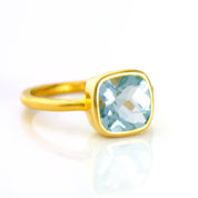 blue topaz gold plated cushion bezel square stacking ring on white background. december birthday, december gemstone. stacking ring, stackable, ring stack, square bezel set, bezel setting