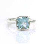 blue topaz in sterling silver cushion square stacking ring on white background. december birthday, december gemstone