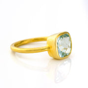 blue topaz gold plated cushion square stacking ring on white background. december birthday, december gemstone