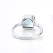 sterling silver blue topaz december birthstone ring facing away december gemstone, cushion cut on white background