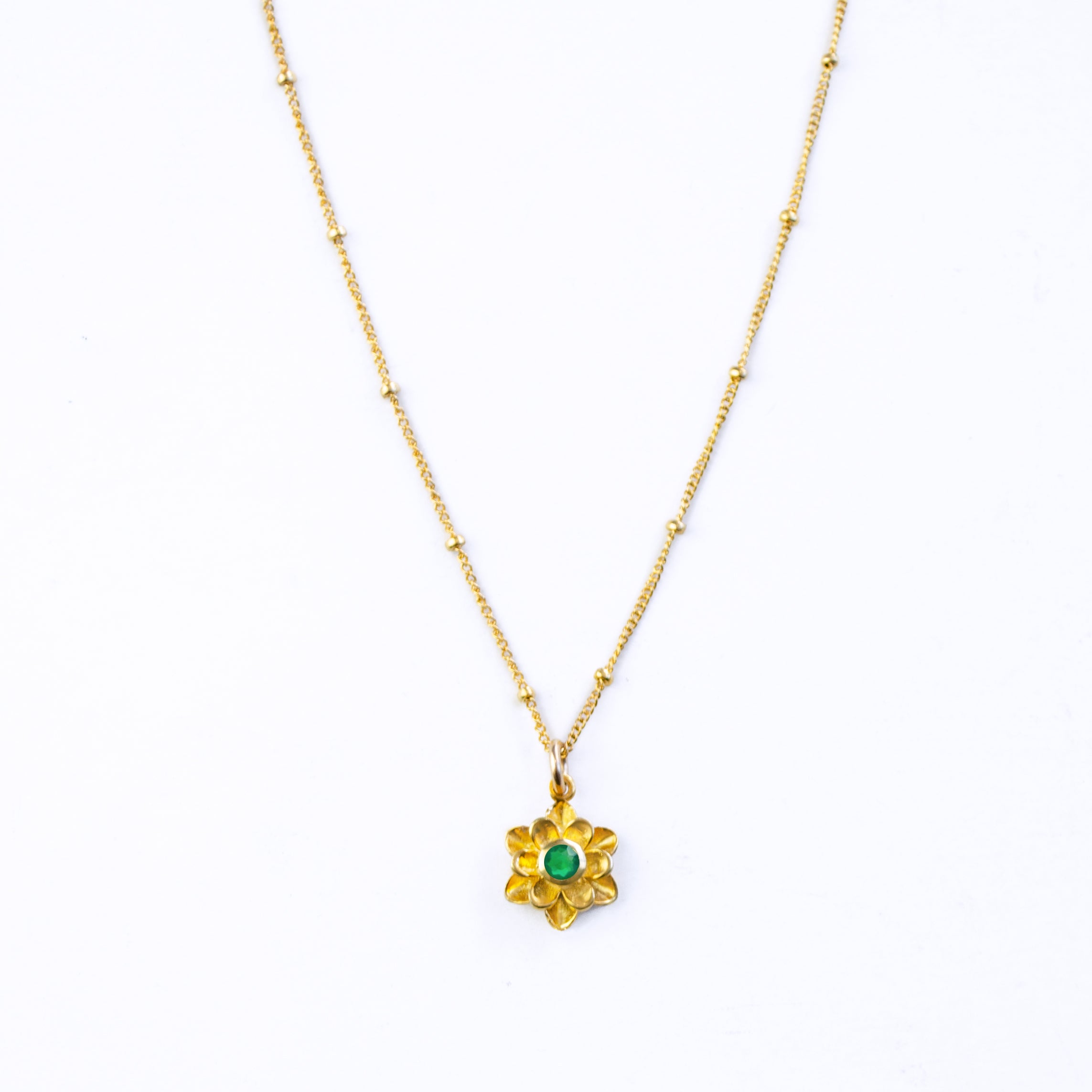 Single old filled satellite chain mothers bloom necklace with green onyx birthstone on white background. Gift for mom.