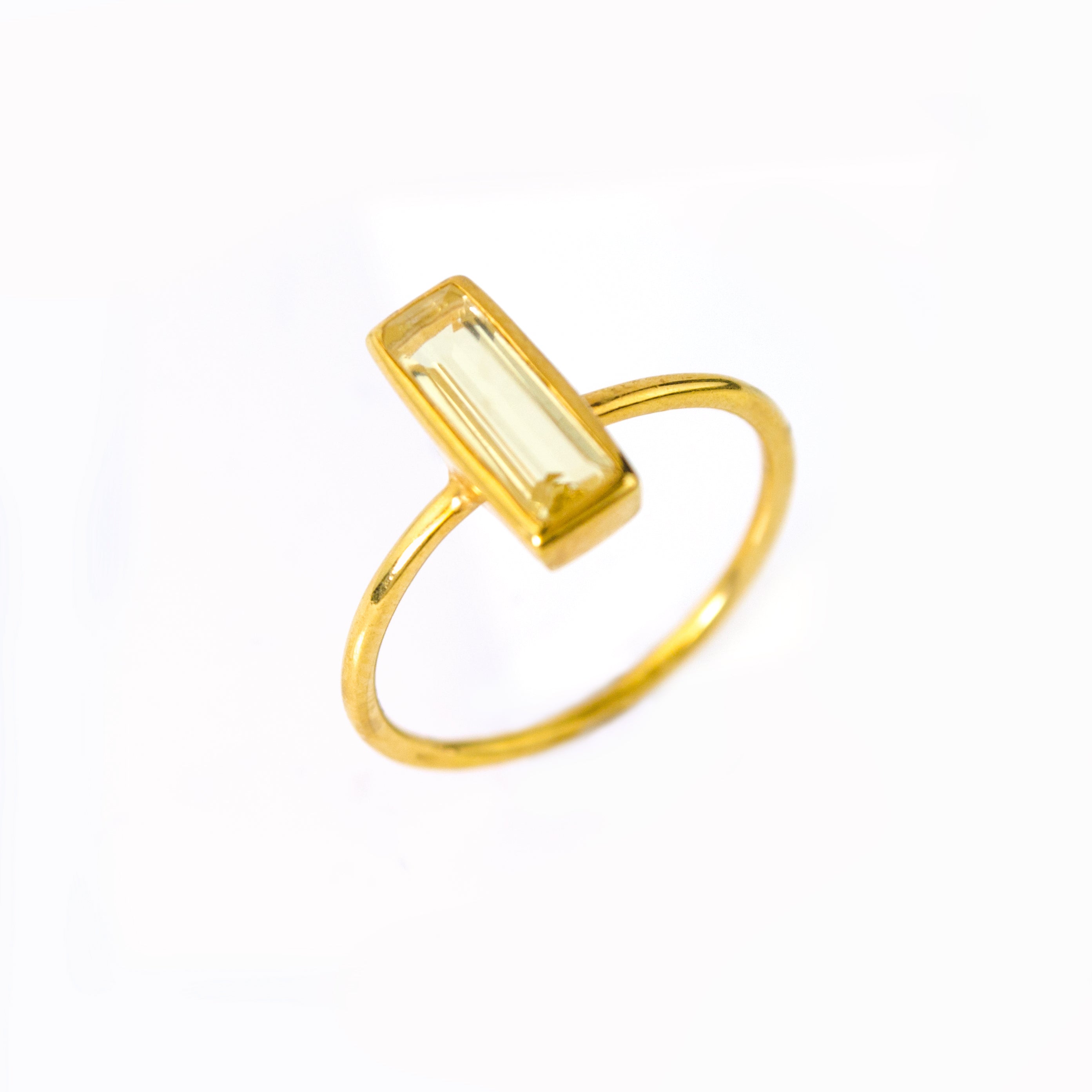 Gold filled tiny gemstone adira bar ring with citrine birthstone on white background. November birthstone, november birthday.