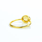 Small oval citrine birthstone november gemstone ring facing away, back view. Bezel set tiny ring. 