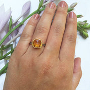 Model is wearing Citrine gold plated cushion bezel square White topaz pave stacking ring 