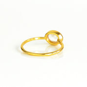 rear view of a gold clear quartz ring shown on white background. stackable. Stacking rings, bezel set, small oval, dainty oval, birthstone rings, sterling silver stamp, birthstone ring, birthstone jewelry, clear gemstone, clear quartz birthstone, april birthstone, april gemstone,  stack set, stacking rings, christmas gift, birthstone ring, mother's day gift for her, gift for mom, gift for fiance, gift for girlfriend, wedding jewelry, bridesmaid jewelry, anniversary jewelry, anniversary gift, birthday gift