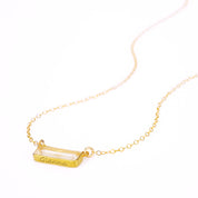Single gold filled cable chain with horizontal clear quartz birthstone and secret message engraved on bottom of bar in script font