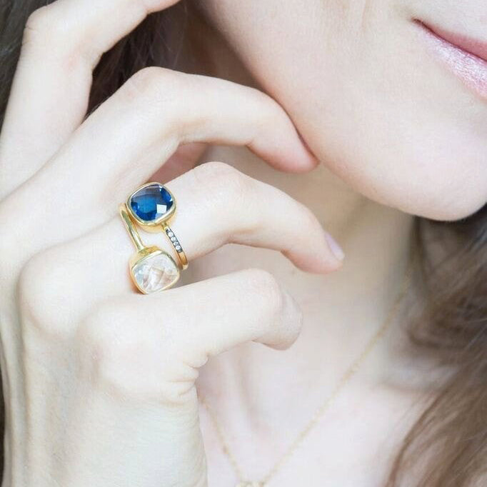 Model is stacking the moonstone cushion and kyanite pave cushion rings in gold plating. stacking rings, stackable rings. 