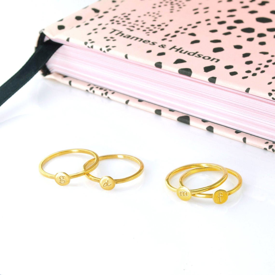 four gold signet letter rings shown with m, g, d and f engraved in typewriter, classic, script or sunshine fonts. 