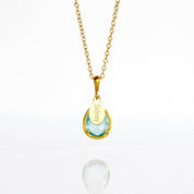 December Sky Blue Quartz Gold Necklace with with personalized engraved name tag in gold plating on white background. Teardrop birthstone december gemstone december birthday light blue