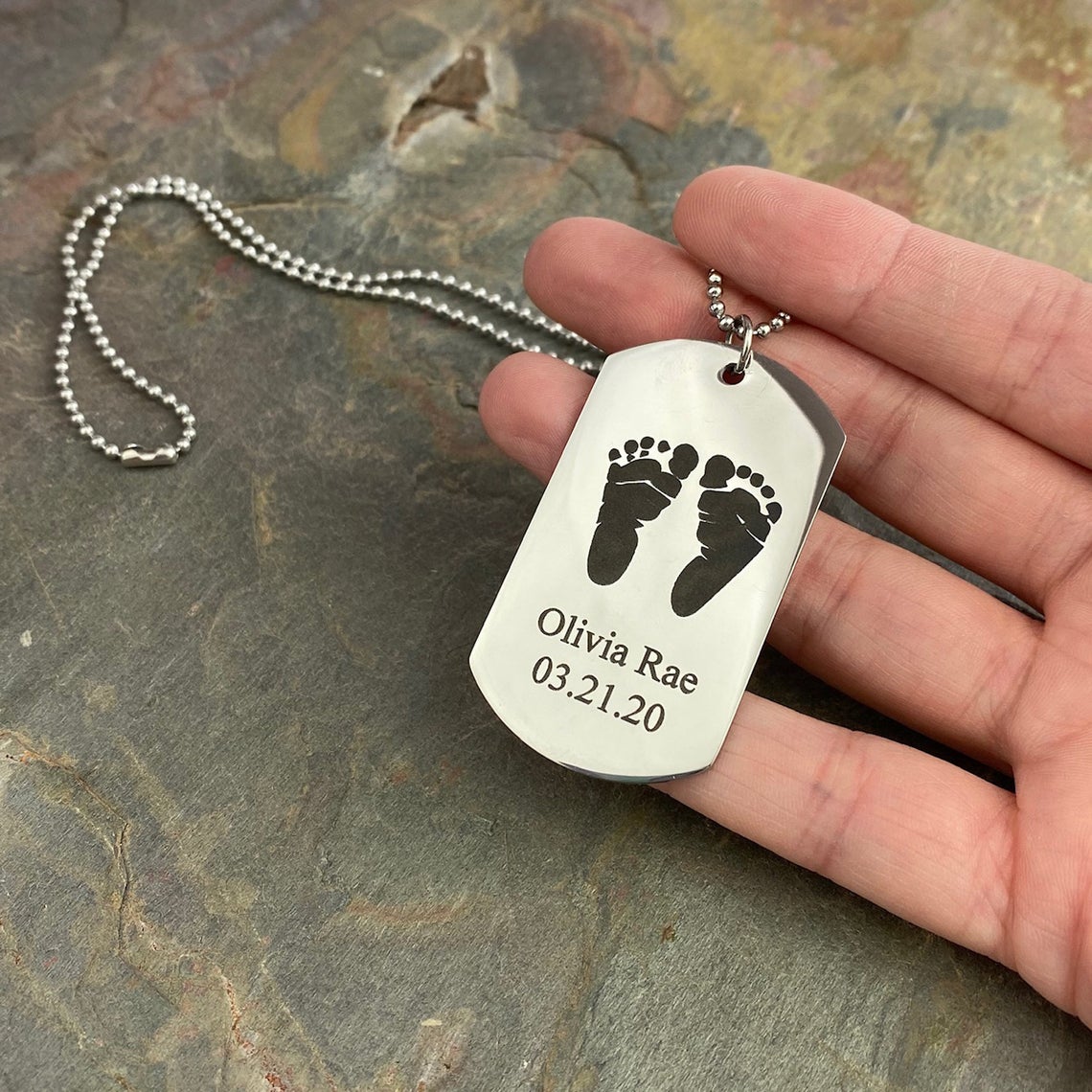 Traditional dog tag style necklace in silver with baby's feet, name and date of birth dob engraved on one side