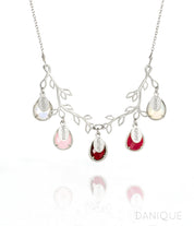 Tree branch necklace in silver with engraved full name tags and moonstone, pink chalcedony, garnet, ruby and opalite birthstones. 