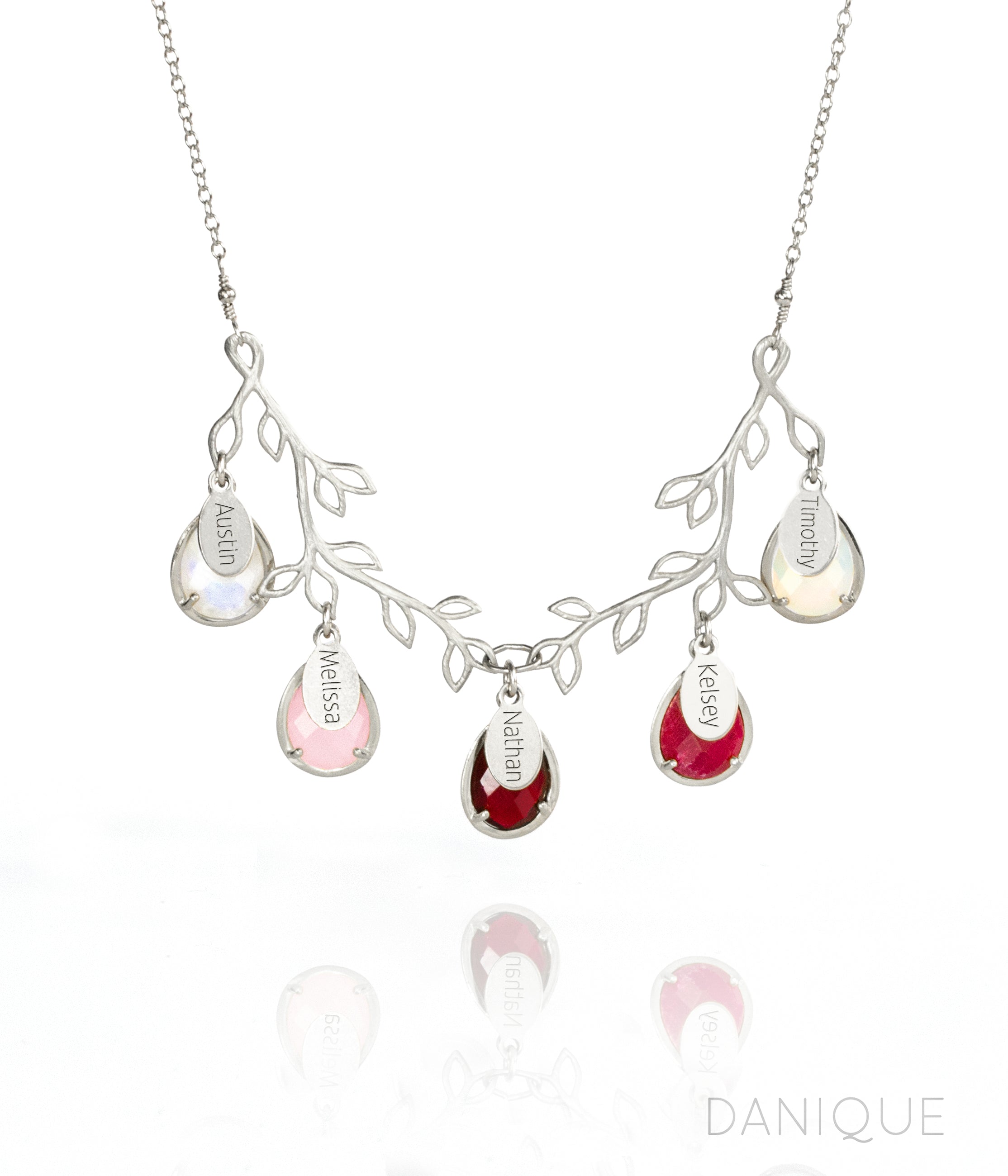 Tree branch necklace in silver with engraved full name tags and moonstone, pink chalcedony, garnet, ruby and opalite birthstones. 