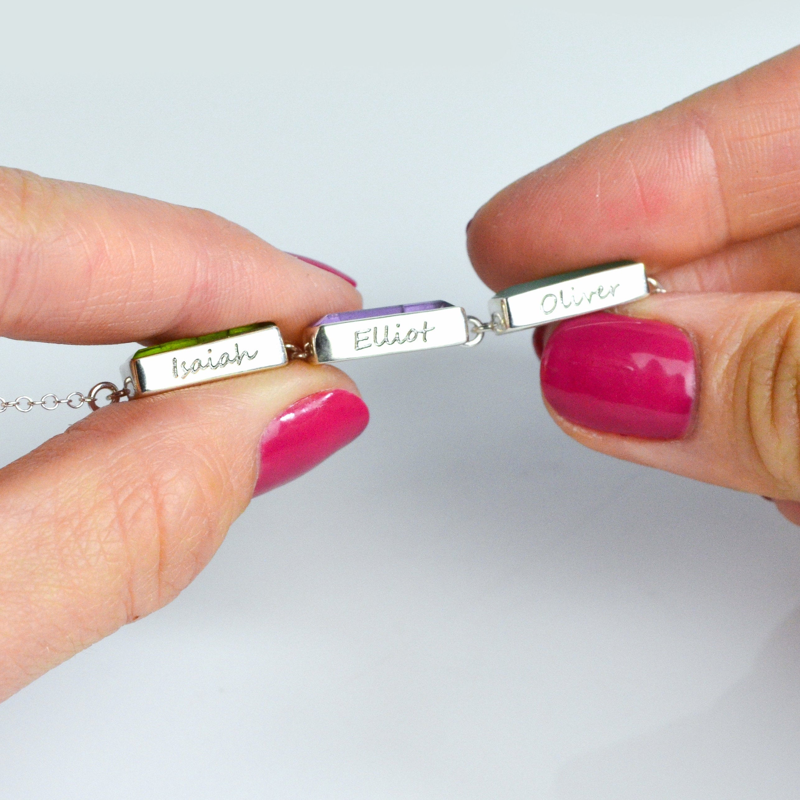 Engravable baguette bar necklace with top and bottom text areas for names, initials, or dates (up to 10 characters each). Create a personalized birthstone necklace for mom with bezel-set stones like Garnet, Amethyst, Aquamarine, Emerald, Ruby, or Sapphire. Hidden message option makes this a sentimental keepsake for new moms, grandmothers, or daughters on birthdays, weddings, or holidays.
