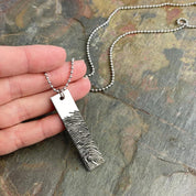 One silver rectangle military necklace with finger print from photo to memorialize a friend or family member. 