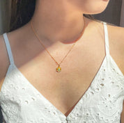 Model in white top is wearing the mothers bloom pendant with aqua chalcedony birthstone and gold filled satellite chain. 