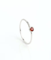 sterling silver dainty 3mm garnet gemstone ring. January birthstone. On white background. 925 sterling silver, birthstone ring, stacking ring, stackable, birthstone jewelry, facet gemstone