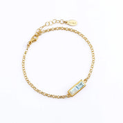 Custom gold multiple baguette birthstone bracelet with four colorful stones, perfect for family jewelry, bridal, or birthday gifts.