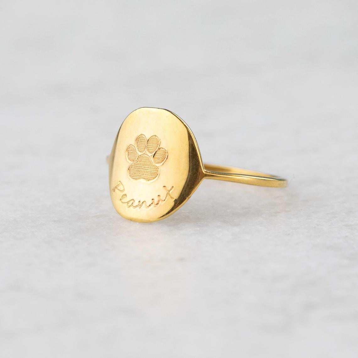 Custom engraved paw print gold plated ring with name peanut. Great gift for dog mom or dog dad for gotcha day, birthday or anniversary.