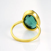 Side profile of oval green tourmaline bezel set ring in 14k gold, modern minimalist gemstone engagement alternative ring, October birthstone jewelry gift