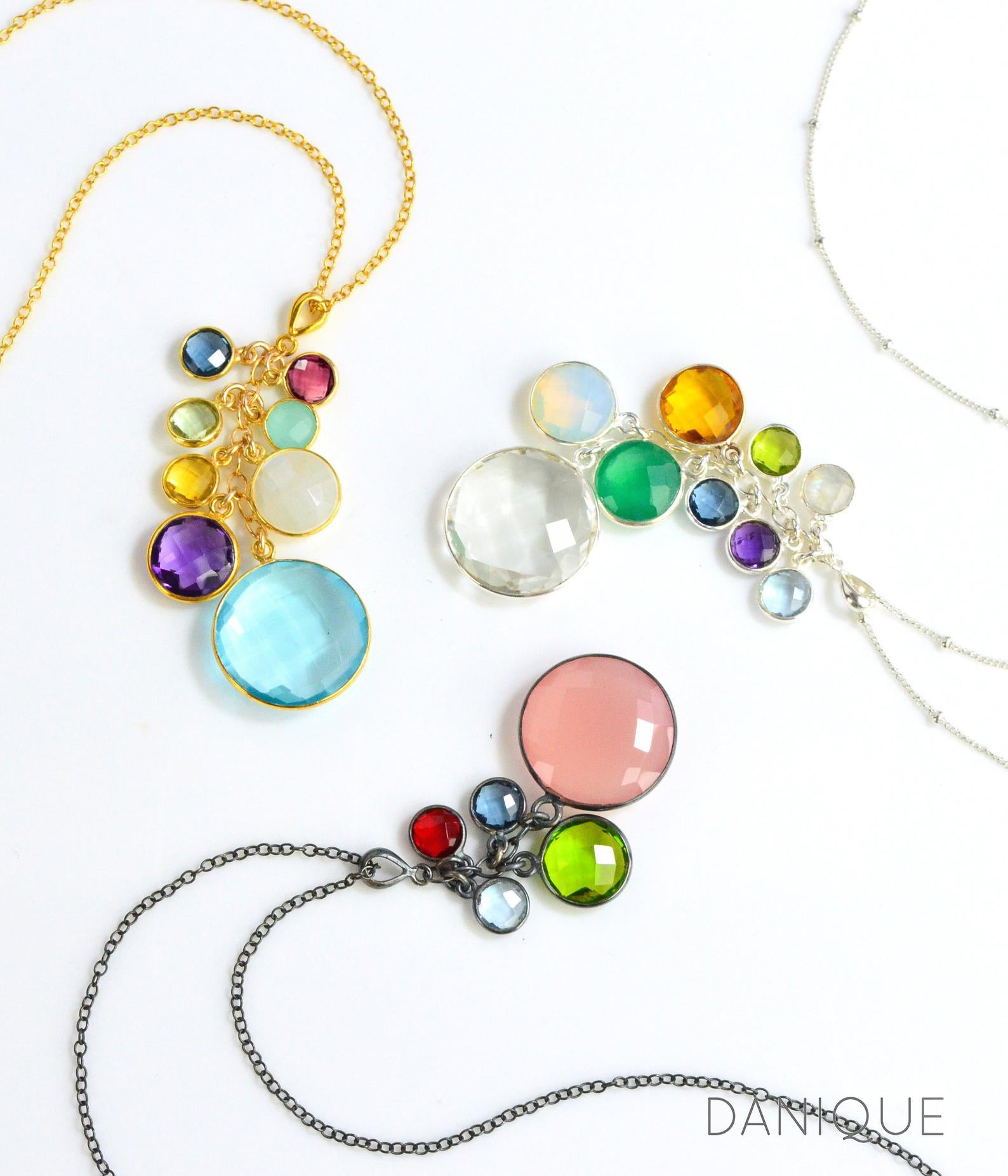 Gift for Grandma Family Necklace With Kids and3 cascade birthstone necklaces in gold, silver and oxidized silver lay in a swirling pattern on a white background. Grandkids Birthstones Gold or Silver, October birthstone necklace for grandma, December birthstone necklace for grandma, April birthstone necklace for grandma, personalized birthstone jewelry for grandmother