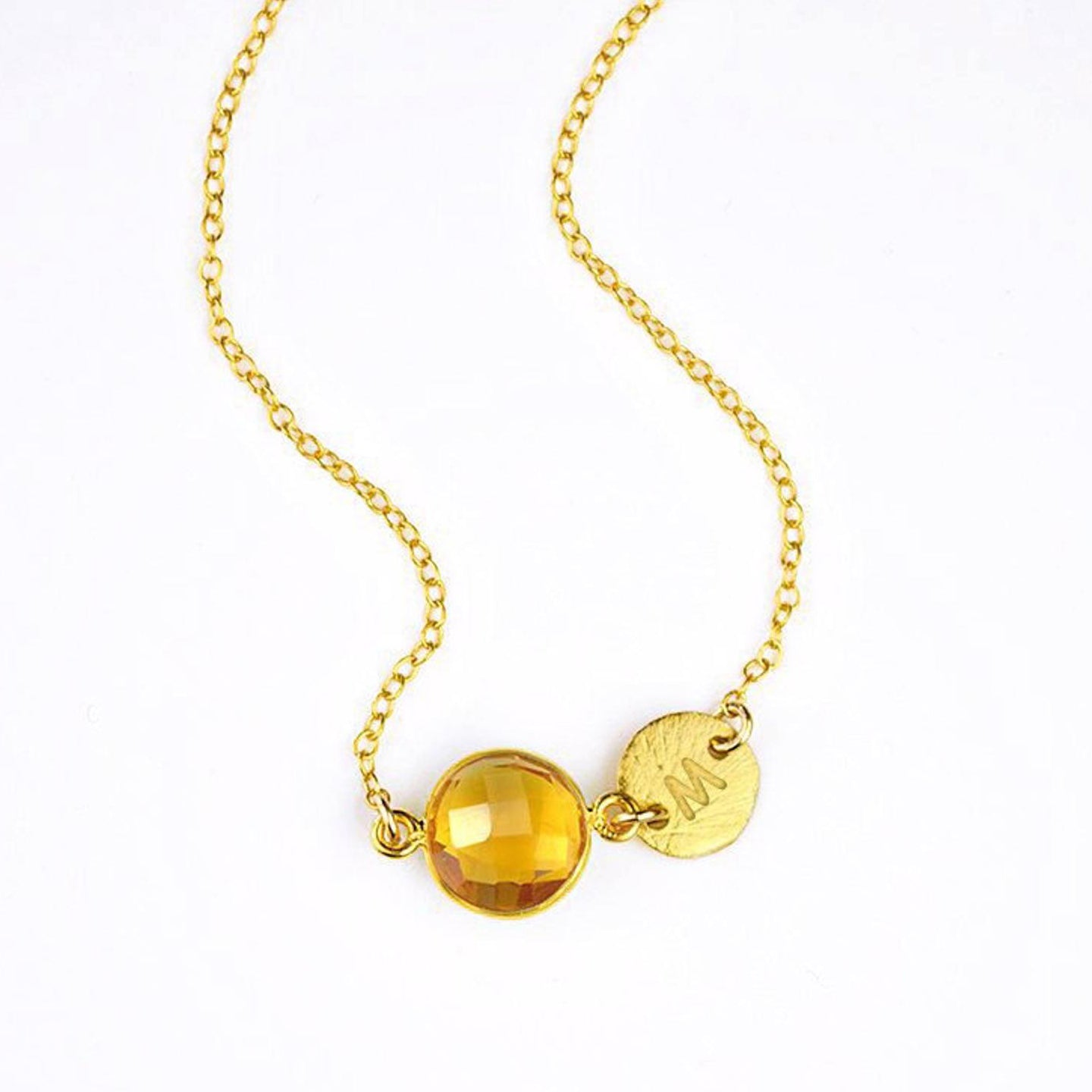 Single gold filled citrine birthstone november birthstone jewelry necklace with brushed initial disk on a white background.