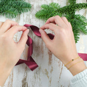 layered bracelet, satin ribbon, white sweater