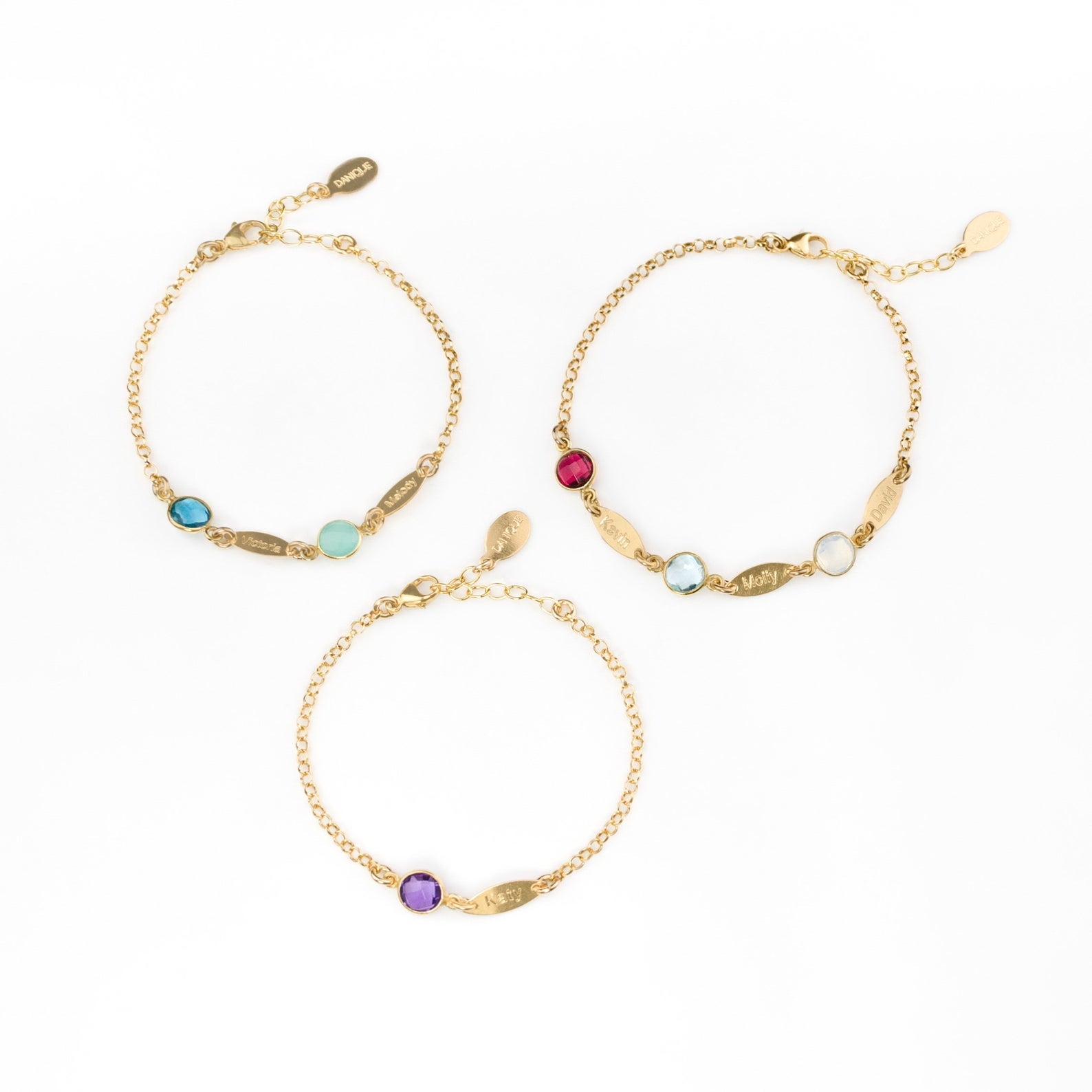 Three adjustable gold filled birthstone marquis bracelets with lobster clasp. First bracelet has kyanite and aqua chalcedony stones. Middle bracelet has a single purple amethyst birthstone. The third bracelet has three stones garnet, blue topaz and clear. 