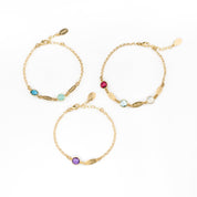Three adjustable gold filled birthstone marquis bracelets with lobster clasp. First bracelet has kyanite and aqua chalcedony stones. Middle bracelet has a single purple amethyst birthstone. The third bracelet has three stones garnet, blue topaz and clear. 