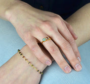 Model is wearing a gold plated two stone prong set birthstone ring with aqua chalcedony and blue topaz birthstones. 