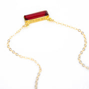 Single gold filled cable chain horizontal garnet quartz january birthstone adira bar necklace with top engraved secret message on white background, gemstone adira bar connectors. birthstone jewelry, birth month jewelry, birthstone necklace, jewelry gift, necklace gift for her, anniversary gift, christmas gift, valentine's day gift, wedding jewelry, bridesmaid's jewelry, gift for mom, gift for wife, gift for girlfriend, gift for grandma, mother's day gift